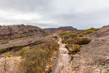 Walking trail among rugged cliffs up the Hollow Mountain in Grampians National Park