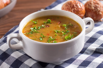 Delicious rustic soup with vegetables, lentils and peas