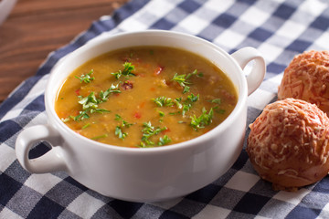 Delicious rustic soup with vegetables, lentils and peas