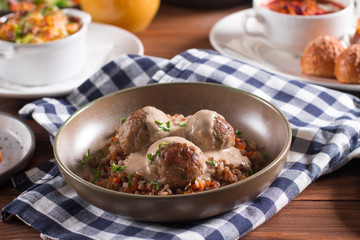 Baked meatballs with creamy mushroom sauce and buckwheat porridge