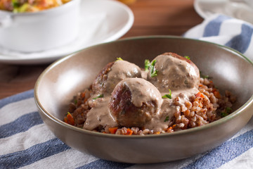 Baked meatballs with creamy mushroom sauce and buckwheat porridge