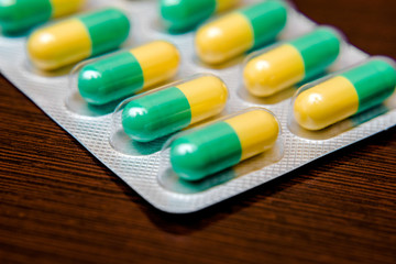 Packaging with pills is on a brown background 