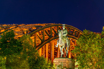 Night view of Hohenzollern bridge behind statue of emperor Wilhelm II in cologne, Germany