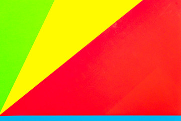 Vibrant multicolor background from cardboard of different colors. Color paper for background. Colorful abstract geometric shapes. Minimalist design for minimal background. Colorful background.