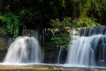 Fototapeta premium Beautiful waterfall in natural 'Si Dit Waterfall' with blue sky in khao kho national park 