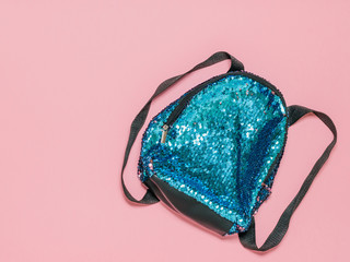 Brilliant blue toddler backpack on a pink background. Baby accessories. The view from the top.