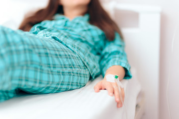 Hand with IV Drip Receiving Medical Treatment