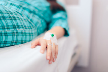 Hand with IV Drip Receiving Medical Treatment