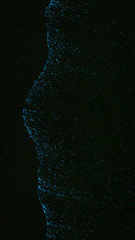 Abstract of blue bioluminescence sparkles on a black beach in the shape of the profile of a human face