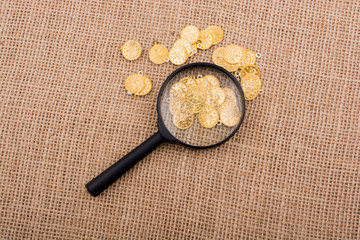 Magnifying glass and plenty of fake gold coins