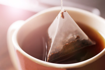 Triangular tea bag in Cup so close