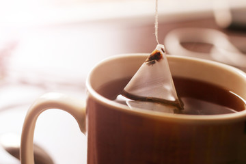 Triangular tea bag in Cup so close