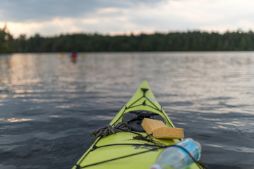 a neon kayak with a water bottle and a sponge