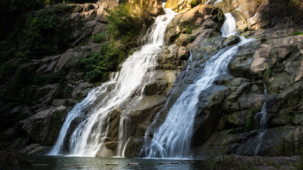 Fototapeta na wymiar Bokeh of natTropical rainforest waterfallure background