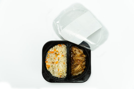 Top view Ready to eat chilled fried rice with chicken in plastic box isolated on white background