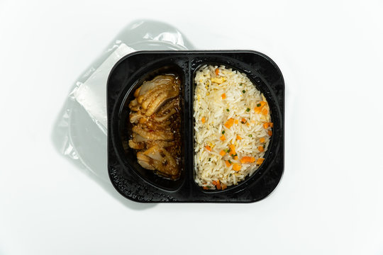 Top view Ready to eat chilled fried rice with chicken in plastic box isolated on white background