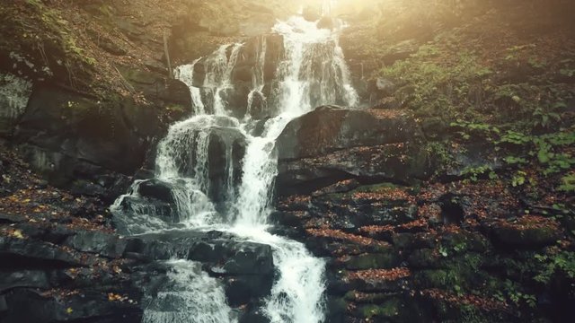 Fast Wild Nature Highland Stream Flow Stony Ground. Mountain Waterfall Creek Motion Rocky Slope Overview. Brook Cascade Soft Sun Beam Eco Friendly Environment Concept Drone Flight Footage 4K (UHD)
