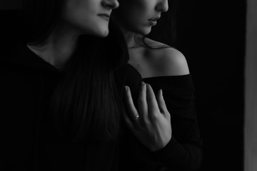 fashion black and white photo of two beautiful girls with dark hair