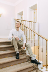 Fototapeta premium Portrait of a man in the European style. The preparations of the groom before the ceremony.
