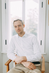 Portrait of a man in the European style. The preparations of the groom before the ceremony.