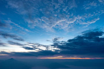 Fototapeta na wymiar Morning dark sky with the blue cloud and rim light of the sunrise on the top of mountaing view of north side of Chaing-rai provice,Thailand.