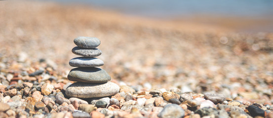 Balance of stones on the beach, sunny day