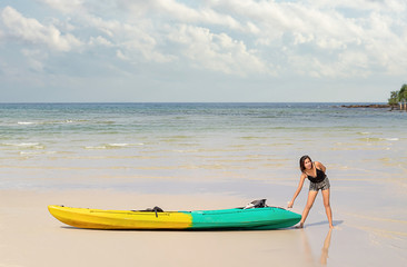 Asian women and kayaks on the beach Background sea and sky at Koh Kood, Trat in Thailand.