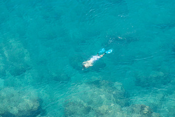 doing snorkeling in tropical sea  