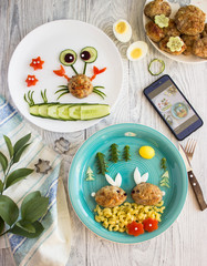 Creative idea for kid breakfast on a white wooden background . Healthy and fun food for kids. Home made food. Concept for a tasty and hearty meal. Meatball