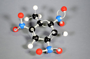 Molecule model of TNT (Trinitrotoulene). Red is oxygen, black is carbon, blue is nirogen and white is hydrogen.