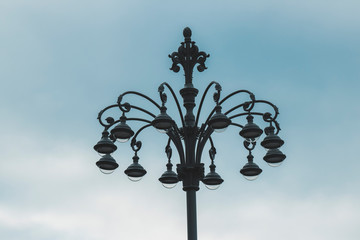 Fototapeta na wymiar old street lamp on a blue background