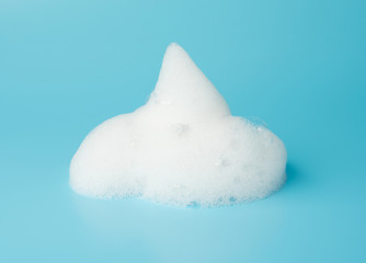 Soap foam bubble isolated on blue background object beatuy health care concept