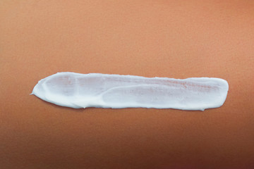 Woman applying sun cream lotion on legs. Skin care.  A Female  with sunscreen on beautiful legs on beach. Sun protection