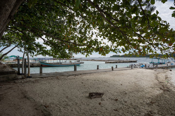 Fototapeta na wymiar Traditional port with several fishing boats to transport tourists to visit the small island island around the island of Harapan, Indonesia