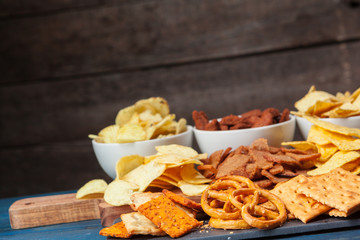wide selection of snacks for beer on wooden background