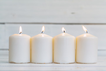 home lighting candles on wooden table