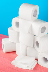 Toilet paper stack on bright blue background