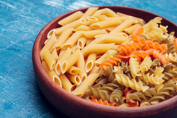 Italian pasta in plate on a blue wooden table