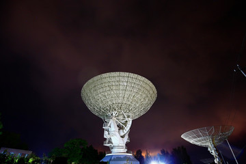 The silhouette of a radio telescope observatory