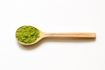 Matcha. Japanese powdered green tea in a spoon on a white background.