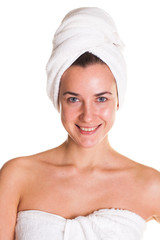 Young woman without makeup in a bath towel on her head, isolated on white