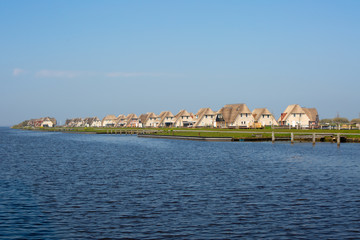 Fototapeta na wymiar Holiday homes on the waterfront in Friesland, the Netherlands.