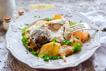 Boiled fish with baked potatoes with sour cream sauce.