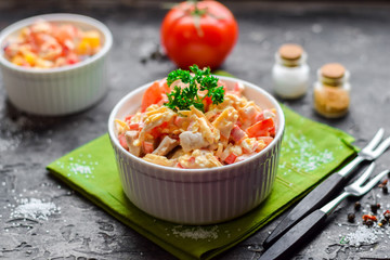 Salad from ham, crab sticks and fresh vegetables.