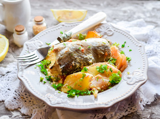 Boiled fish with baked potatoes with sour cream sauce.