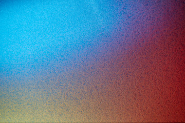 Red yellow and blue textural background in blur