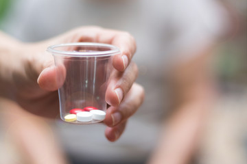 Caregiver or nurse give medicine to happy elderly senior patient in hospice care centre or...