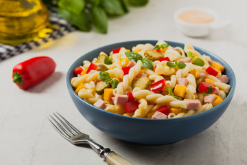 Italian fusilli pasta in a salad with ham and vegetables.