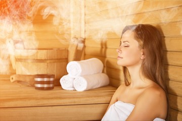 Obraz na płótnie Canvas Young woman relaxing in bathhouse