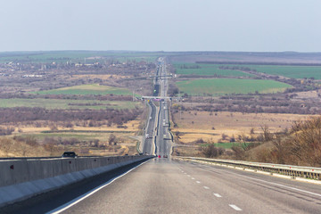Straight road. Straight highway. Bilateral movement. Dividing line. Car country traffic. Travelling...